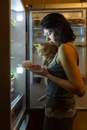 woman looking in fridge