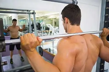 male bodybuilder working shoulder muscles