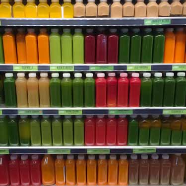 bottles of different colored raw juices