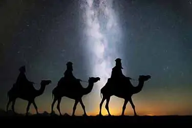 Biblical magi on camels during starry night