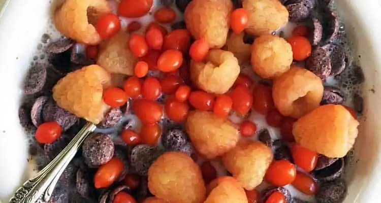 purple corn flakes with orange raspberries and fresh goji