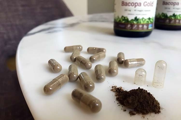 bacopa supplement bottle with open capsule on table
